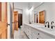 Double vanity in bathroom featuring wood doors, white countertops, black fixtures, and a large mirror offering plenty of counter space at 504 Telfair Park, Peachtree City, GA 30269