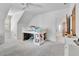 Bright bedroom with a loft bed, a large window, a ceiling fan, and plush gray carpeting provides a cozy and modern feel at 504 Telfair Park, Peachtree City, GA 30269