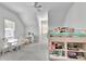 Bright bedroom with a loft bed, a large window, a ceiling fan, and plush gray carpeting provides a cozy and modern feel at 504 Telfair Park, Peachtree City, GA 30269