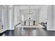 Dining room with a modern chandelier, white chairs, and views of the living room at 504 Telfair Park, Peachtree City, GA 30269