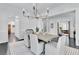 Dining room with stylish chandelier, modern rug, and views into other rooms at 504 Telfair Park, Peachtree City, GA 30269