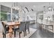 Open concept dining room boasts modern lighting and connects seamlessly to the kitchen and living spaces at 504 Telfair Park, Peachtree City, GA 30269