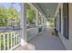 Spacious covered front porch with white columns, ceiling fans, and views of the landscaped yard at 504 Telfair Park, Peachtree City, GA 30269