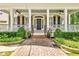 Inviting front porch with brick walkway, ceiling fans, and meticulously manicured landscaping at 504 Telfair Park, Peachtree City, GA 30269