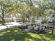 Landscaped front yard with well-maintained lawn, trees, and a charming gazebo and plantings at 504 Telfair Park, Peachtree City, GA 30269
