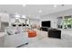 Open-concept living room with a comfortable seating arrangement, bar, and large windows at 504 Telfair Park, Peachtree City, GA 30269