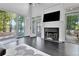 Living room with fireplace, large windows and deck access provides stunning views of the backyard at 504 Telfair Park, Peachtree City, GA 30269