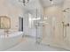 Bright main bathroom with a modern glass shower, soaking tub, and marble countertops at 504 Telfair Park, Peachtree City, GA 30269