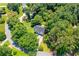 Aerial view of the home nestled among mature trees, showcasing its private and lush surroundings at 5870 Shadewater Dr. Dr, Cumming, GA 30041