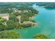 Aerial view showcasing the lake and community amenities, including parking, boat docks and a bridge at 5870 Shadewater Dr. Dr, Cumming, GA 30041