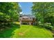 Well-maintained backyard with a deck, patio, lush lawn, and mature trees at 5870 Shadewater Dr. Dr, Cumming, GA 30041