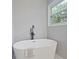 Bright bathroom with a sleek soaking tub, perfect for relaxation and unwinding after a long day at 5870 Shadewater Dr. Dr, Cumming, GA 30041