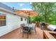 Spacious wooden deck with an umbrella and multiple grills, perfect for outdoor dining and entertainment at 5870 Shadewater Dr. Dr, Cumming, GA 30041
