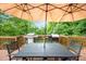 Outdoor deck area featuring table, chairs, and grill; ideal for entertaining and enjoying outdoor meals at 5870 Shadewater Dr. Dr, Cumming, GA 30041