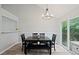 Bright dining area featuring chandelier, table with bench, and sliding glass door to outside deck at 5870 Shadewater Dr. Dr, Cumming, GA 30041