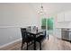 Bright dining area featuring modern chandelier, table with bench, and sliding glass door to outside deck at 5870 Shadewater Dr. Dr, Cumming, GA 30041