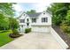 Charming two-story home features a well-manicured lawn, two-car garage and classic architectural details at 5870 Shadewater Dr. Dr, Cumming, GA 30041