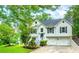 Charming two-story traditional home with a two car garage, landscaping, and inviting curb appeal at 5870 Shadewater Dr. Dr, Cumming, GA 30041