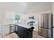 Bright modern kitchen with white cabinets, stainless steel appliances, and kitchen island at 5870 Shadewater Dr. Dr, Cumming, GA 30041