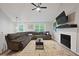 Comfortable living room with a large sectional sofa, fireplace, and abundant natural light at 5870 Shadewater Dr. Dr, Cumming, GA 30041