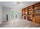 Study with built-in wooden shelves and French doors leading to outdoor seating at 5870 Shadewater Dr. Dr, Cumming, GA 30041