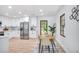 Modern kitchen features white cabinets, stainless steel appliances, and adjacent dining area at 911 Oakland Sw Dr, Atlanta, GA 30310