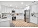 Modern kitchen features white cabinets, stainless steel appliances, and wood-look floors at 911 Oakland Sw Dr, Atlanta, GA 30310