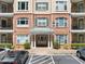 Brick building exterior featuring balconies, ample parking, and well-maintained landscaping at 2303 Stratford Commons Commons, Decatur, GA 30033