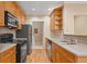 Kitchen with wooden cabinets, stainless-steel appliances, and tiled backsplash at 2303 Stratford Commons Commons, Decatur, GA 30033