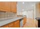 Bright kitchen features tile countertops, stainless steel dishwasher, and light wood cabinets at 2303 Stratford Commons Commons, Decatur, GA 30033