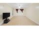 Bright living room featuring a ceiling fan, neutral carpet, and large window at 2303 Stratford Commons Commons, Decatur, GA 30033