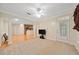 Bright living room featuring a ceiling fan, neutral carpet, and access to kitchen at 2303 Stratford Commons Commons, Decatur, GA 30033