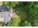 Aerial view of a home with a deck, a large lawn, and mature trees providing privacy at 4392 Windsor Oaks Cir, Marietta, GA 30066