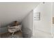Finished attic space with seating and a neutral color palette at 4392 Windsor Oaks Cir, Marietta, GA 30066