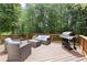 Inviting outdoor back deck with grill and comfortable seating area at 4392 Windsor Oaks Cir, Marietta, GA 30066