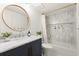 Bright bathroom featuring a marble countertop, built in shower niche and stylish finishes at 4392 Windsor Oaks Cir, Marietta, GA 30066