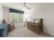 Charming Bedroom with a crib, rocking chair, and soothing decor, perfect for a baby's room at 4392 Windsor Oaks Cir, Marietta, GA 30066