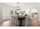 Elegant dining room with wainscoting, shuttered windows, and a view into the kitchen at 4392 Windsor Oaks Cir, Marietta, GA 30066