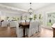 Bright dining room with hardwood floors, elegant chandelier, and white slip-covered chairs at 4392 Windsor Oaks Cir, Marietta, GA 30066