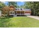 Charming brick home with manicured lawn and inviting front porch at 4392 Windsor Oaks Cir, Marietta, GA 30066