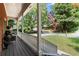 Inviting covered front porch with classic railings and an American flag, showcasing a welcoming entrance at 4392 Windsor Oaks Cir, Marietta, GA 30066