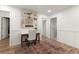 Upstairs hallway with stylish wainscotting, wood floors, and a decorative rug at 4392 Windsor Oaks Cir, Marietta, GA 30066