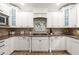 Beautiful kitchen with white cabinets, granite countertops, stainless appliances, and decorative tile backsplash at 4392 Windsor Oaks Cir, Marietta, GA 30066