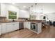 Well-lit kitchen featuring stainless steel appliances, custom cabinets, granite countertops, and hardwood flooring at 4392 Windsor Oaks Cir, Marietta, GA 30066