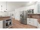 Modern kitchen boasting stainless steel appliances, custom cabinets, granite countertops, and a large refrigerator at 4392 Windsor Oaks Cir, Marietta, GA 30066
