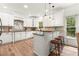 Spacious kitchen featuring custom white cabinetry, granite countertops, and a center island with bar seating at 4392 Windsor Oaks Cir, Marietta, GA 30066