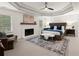 Spacious primary bedroom with tray ceilings, fireplace, sitting area, and large windows at 4392 Windsor Oaks Cir, Marietta, GA 30066