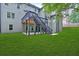 Lush green lawn and a deck with stairs leading to a patio, offering a serene outdoor living space at 511 Millwood Ct, Canton, GA 30114
