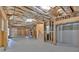 Spacious unfinished basement with insulation, framing and stairs leading upstairs provides flexible potential for customization at 511 Millwood Ct, Canton, GA 30114
