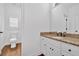 Elegant bathroom featuring granite countertops, white cabinets, and a wood floor at 511 Millwood Ct, Canton, GA 30114